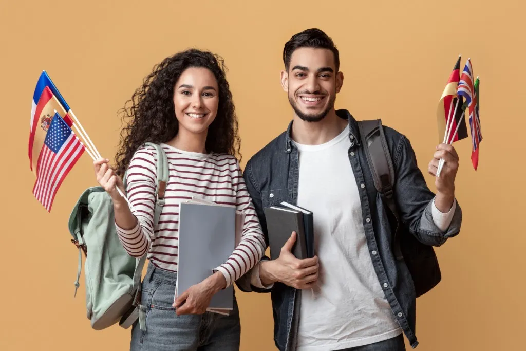 Documentos para estudiar en el extranjero: fotografía de un chico y una chica sosteniendo banderas de países.