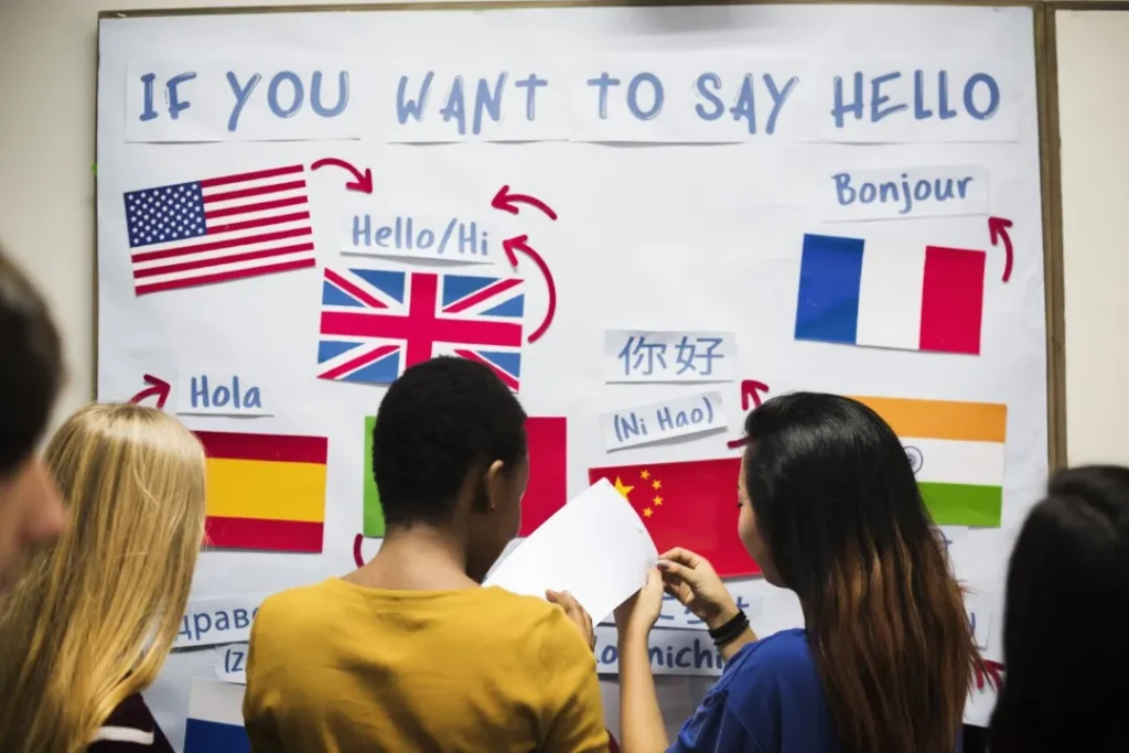 Técnicas de traducción: Fotografía de personas frente a un pizarrón con banderas de diferentes países.